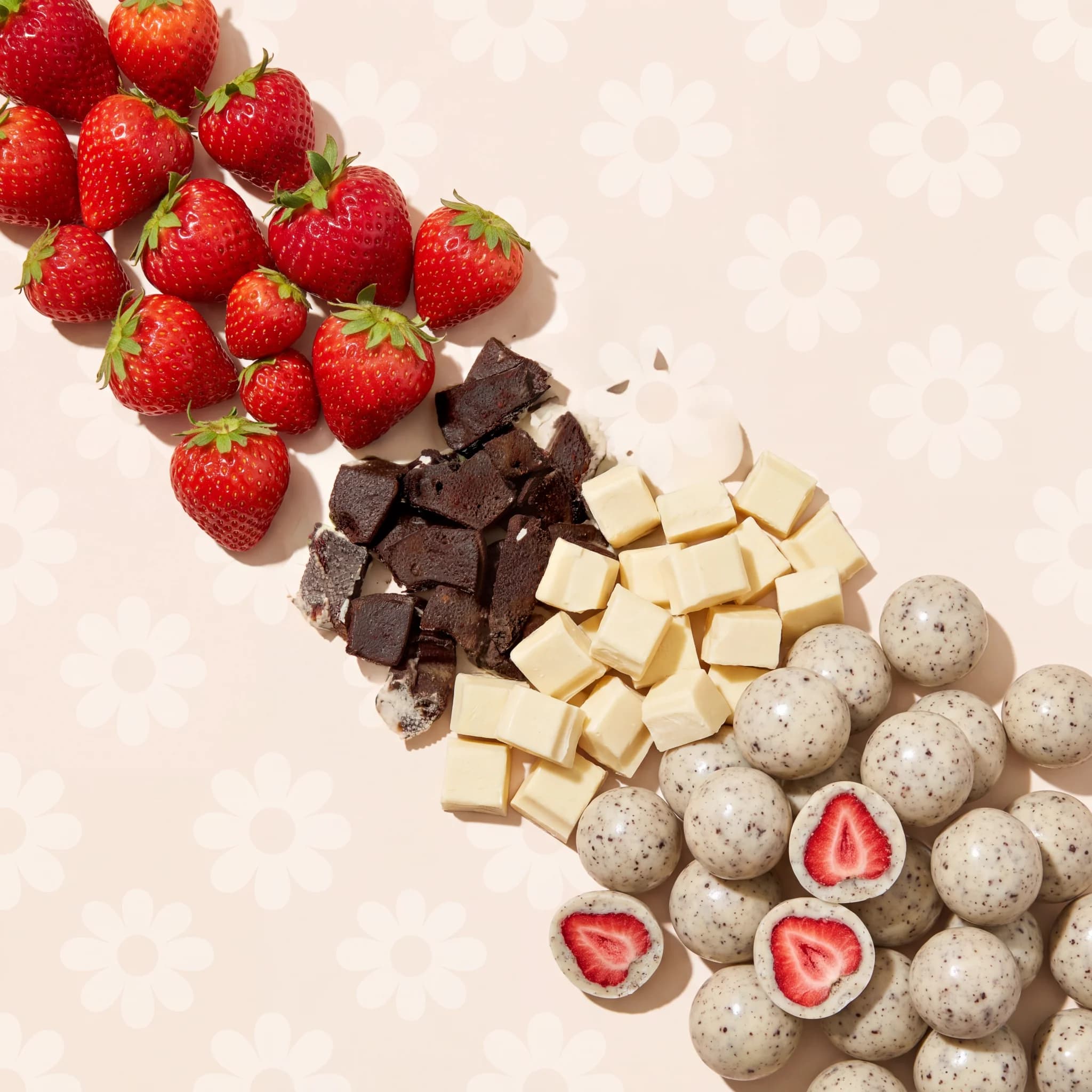 Strawberries, cookie pieces and white chocolate flowing into finished bites